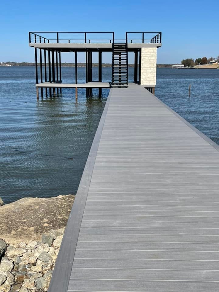 A double layered dock with stairs pictured on the water